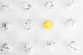 overhead shot of crumpled paper in oder and yellow one standing out on white background. great idea concept Royalty Free Stock Photo