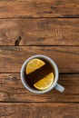 Overhead shot of cup of tea with silce of lemon on white wooden table Royalty Free Stock Photo