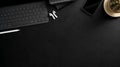 Overhead shot of dark  workplace with  tablet, office supplies, wireless headphone and copy space Royalty Free Stock Photo