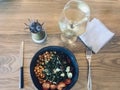 Overhead shot of delicious cooked veggies, a tiny cactus, and a glass of a cold beverage Royalty Free Stock Photo