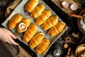 Overhead shot of delicious homemade baked sausages rolled in dough on baking tray