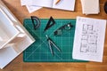 Overhead Shot Of Desk In Architects Office With Plans Drawing Instruments And Model Royalty Free Stock Photo