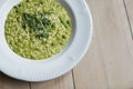 Overhead Shot Of Dish Of Pea And Mint Risotto On Wooden Restaurant Table Royalty Free Stock Photo