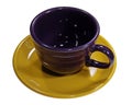 Overhead shot of an empty violet cup placed in a dark yellow small plate Royalty Free Stock Photo