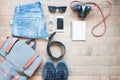 Overhead shot of essentials for traveler. Outfit of young man traveler, camera, mobile device, sunglasses. Royalty Free Stock Photo