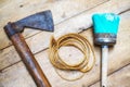 Overhead shot of a flat ax, a spiral rope and a bright blue round brush on a wooden surface Royalty Free Stock Photo