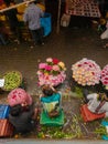 Overhead shot of Flower Vendors sitting with their basket of flower at Dadar flower market, Mumbai