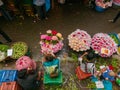 Overhead shot of Flower Vendors sitting with their basket of flower at Dadar flower market, Mumbai