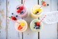 overhead shot of fruit smoothies in mason jars with straws Royalty Free Stock Photo