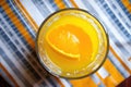 an overhead shot of a glass of orange juice with a squeezer