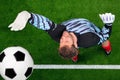 Overhead shot of a goalkeeper missing the ball. Royalty Free Stock Photo