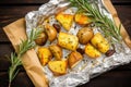 overhead shot of grilled potatoes and rosemary on a wax paper
