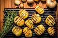 overhead shot of grilled potatoes on wooden chopping board