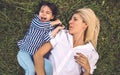 Overhead shot of happy pretty funny woman playing and lying on green grass outdoor with her cute little girl. Loving mother and Royalty Free Stock Photo