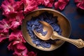 overhead shot of hibiscus petals in a brass scoop