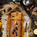 Overhead shot of homemade tasty lemon baked cake with blueberries on paper and sackcloth Royalty Free Stock Photo