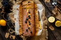 Overhead shot of homemade tasty lemon baked cake with blueberries on paper and sackcloth Royalty Free Stock Photo