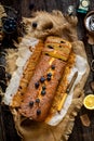 Overhead shot of homemade tasty lemon baked cake with blueberries on paper and sackcloth Royalty Free Stock Photo