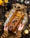 Overhead shot of homemade tasty lemon baked cake with blueberries on paper and sackcloth Royalty Free Stock Photo