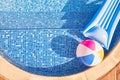 Overhead Shot Of Inflatable Airbed And Beach Ball Floating In Outdoor Swimming Pool Royalty Free Stock Photo