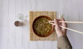 Overhead shot of a Japanese shoop with chopsticks on a white wooden background Royalty Free Stock Photo