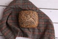 Overhead shot of a loaf of brown bread with sesame seeds on a napkin on the table Royalty Free Stock Photo