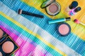 overhead shot of makeup essentials on a colorful beach mat Royalty Free Stock Photo