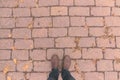 Overhead shot of man standing on brick patterned flooring Royalty Free Stock Photo