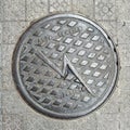 Overhead shot of the metal cover of a sewer in Bilbao.