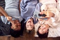 Overhead Shot Of Multi-Cultural Teenage Girl Friends Posing For Selfie On Mobile Phone At Home Royalty Free Stock Photo