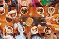Overhead Shot Of Multi-Generation Family Sitting Around Table Enjoying Meal At Home Together Royalty Free Stock Photo