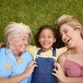 Overhead Shot Of Multi-Generation Female Family Lying On Grass Tickling Granddaughter Royalty Free Stock Photo