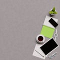 Overhead shot of office desktop. Telephone, tea cup, glasses, pencils, notebook, pen, potted plant on light background.Top view Royalty Free Stock Photo