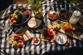 An overhead shot of a picnic blanket spread with delicious food on a sunny meadow Royalty Free Stock Photo