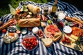 An overhead shot of a picnic blanket spread with delicious food on a sunny meadow