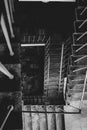 Overhead shot of a rectangular spiral staircase of an old building in grayscale