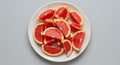 Overhead Shot of Red Grapefruit Slices on White Plate Royalty Free Stock Photo