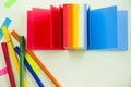Overhead shot of a set of sketch markers with a colorful notepad with space for your text