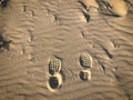 Overhead shot of shoe prints on the sand at a beach in Avola City, Sicily, Italy Royalty Free Stock Photo