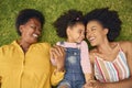 Overhead Shot Of Smiling Multi-Generation Female Family Lying On Grass In Garden Together Royalty Free Stock Photo