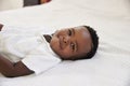 Overhead Shot Of Smiling Young Boy Lying On Bed