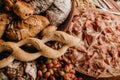 Overhead shot of a table full of bread, prosciutto and grapes