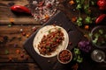 overhead shot of a taco with a whole chili pepper on a rustic wood table
