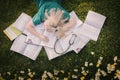 Overhead shot of a tired medical student sleeping on books iat a field