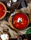Overhead shot of two wooden bowls with tasty Ukrainian or Russian traditional beetroot soup borscht with sour cream Royalty Free Stock Photo