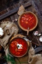 Overhead shot of two wooden bowls with tasty Ukrainian or Russian traditional beetroot soup borscht with sour cream Royalty Free Stock Photo