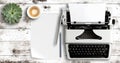 Typewriter and paper on white wooden table Royalty Free Stock Photo