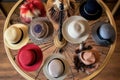 an overhead shot of various womens hat styles on a circular rack