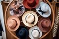 an overhead shot of various womens hat styles on a circular rack