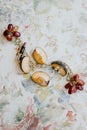 Overhead shot of a vibrant display of fresh apples and grapes with wedding rings and jewelry